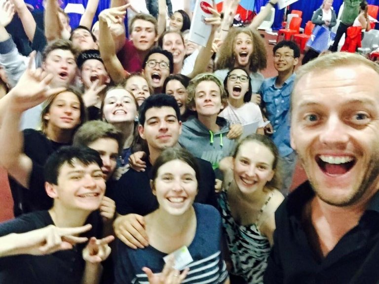 Teenagers celebrating with Brent Williams at an EmpowerU event